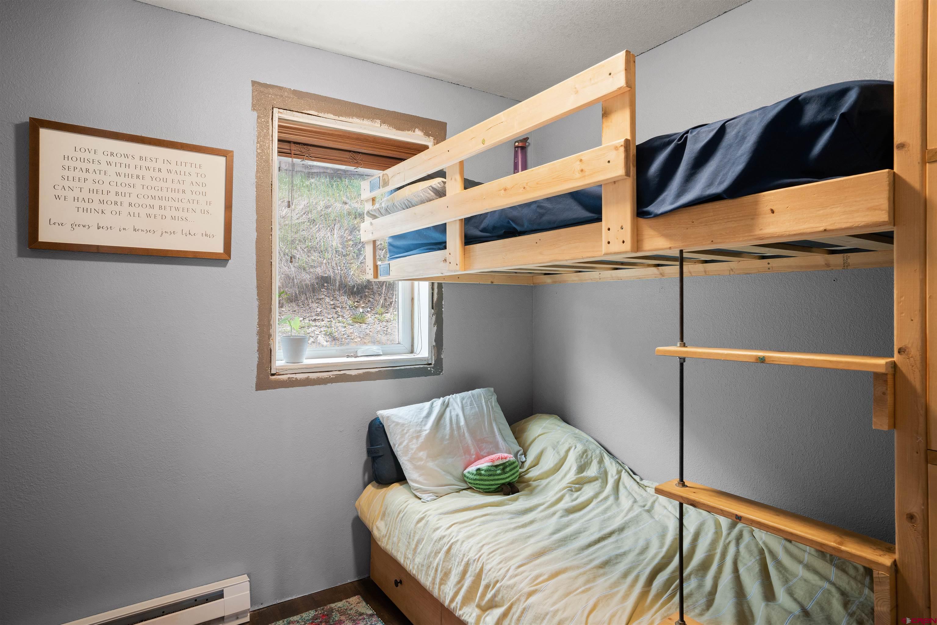 31 Castle Road, Unit 1 Crested Butte, CO 81225 - Photo 10 of 17 a bedroom with a bed and a window