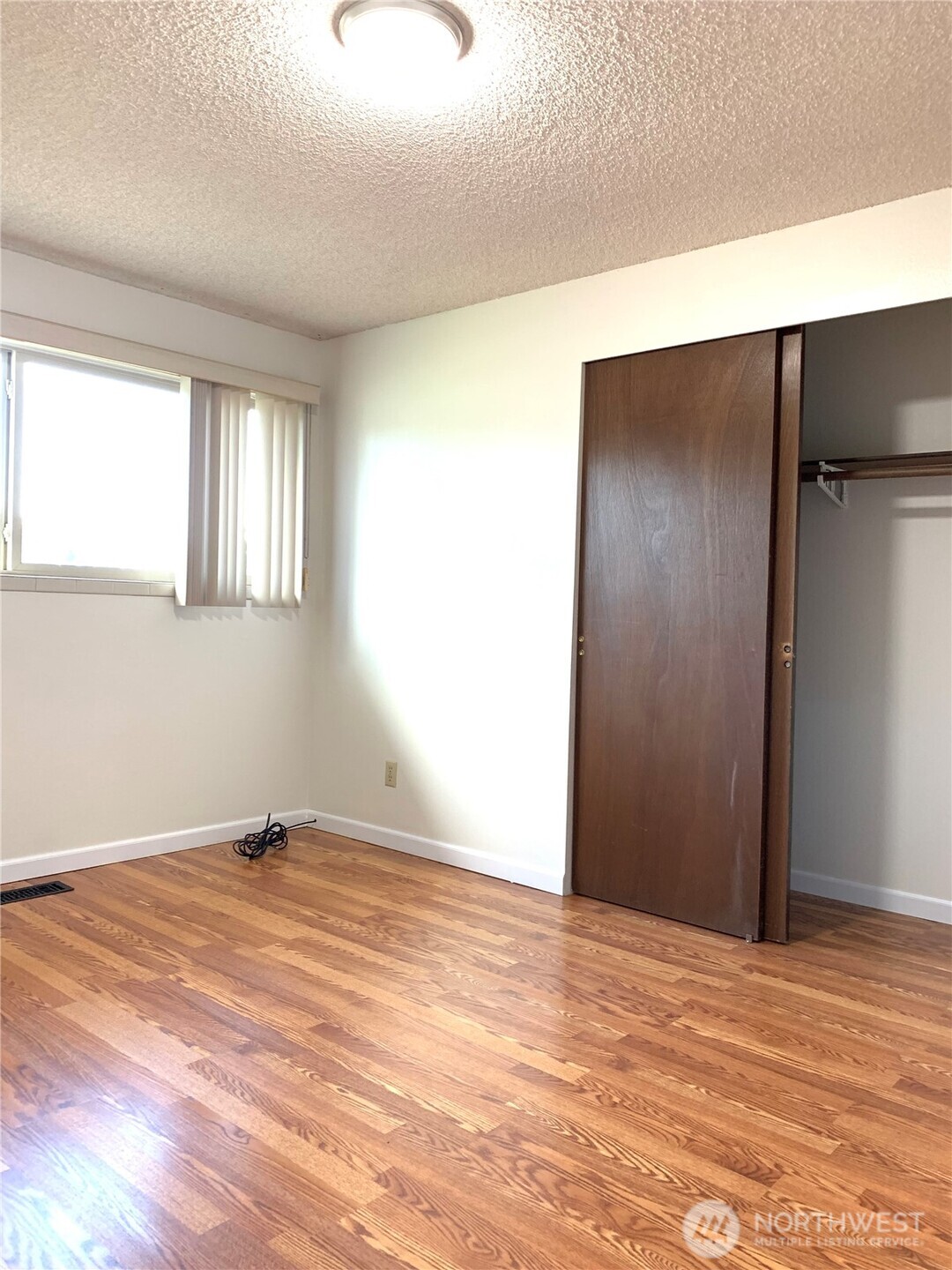 29818 4th Avenue Southwest Federal Way, WA 98023 - Photo 20 of 40 a view of an empty room with wooden floor and a window