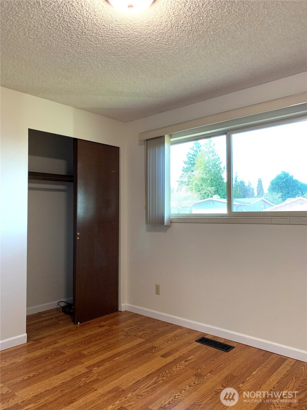 29818 4th Avenue Southwest Federal Way, WA 98023 - Photo 22 of 40 an empty room with wooden floor and windows