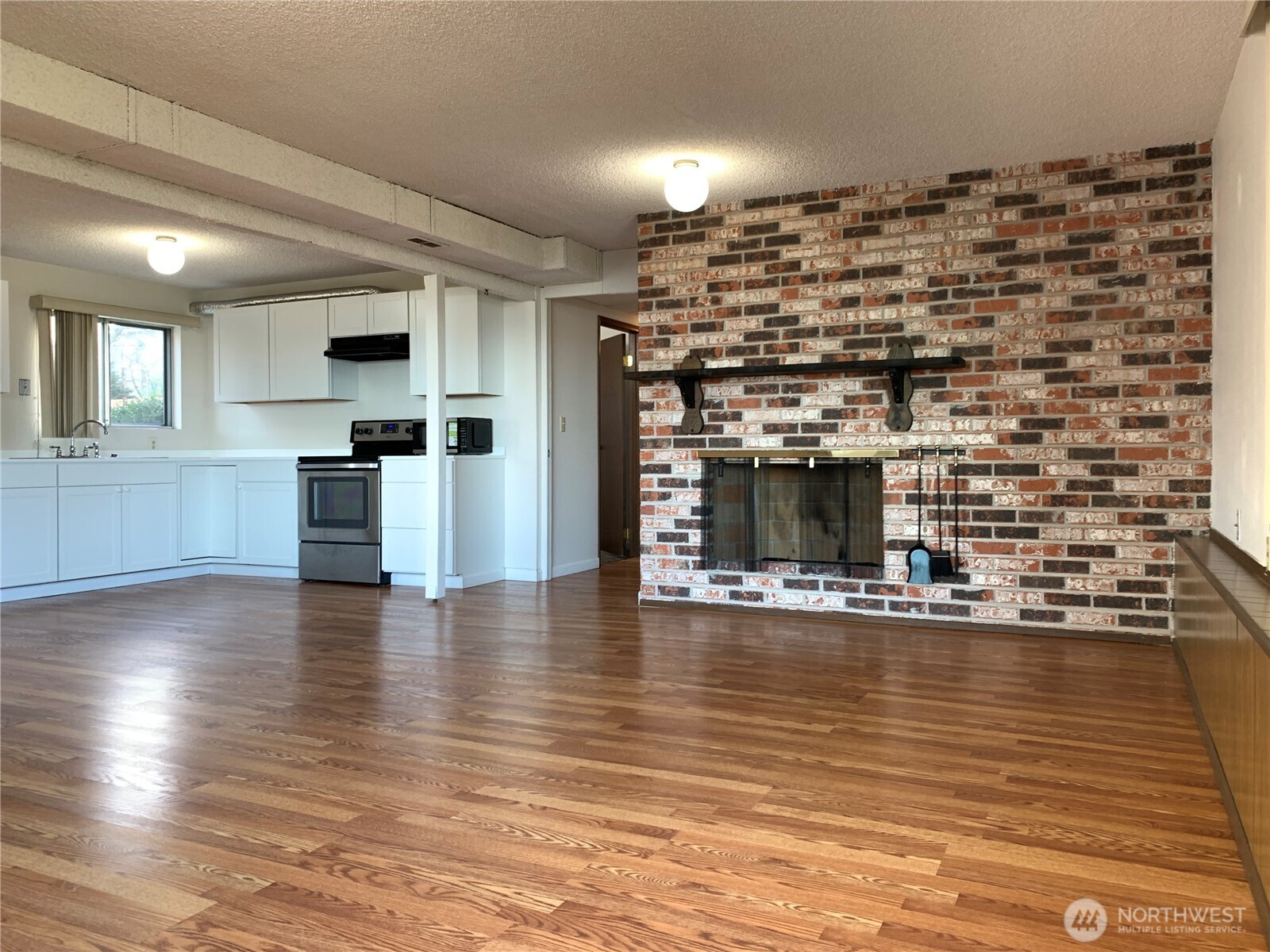 29818 4th Avenue Southwest Federal Way, WA 98023 - Photo 28 of 40 a view of open kitchen with granite countertop a stove and a wooden floor