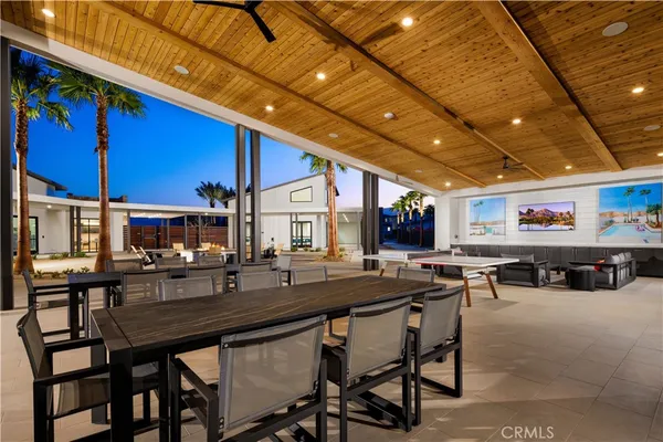 a outdoor dining area with chairs and tables
