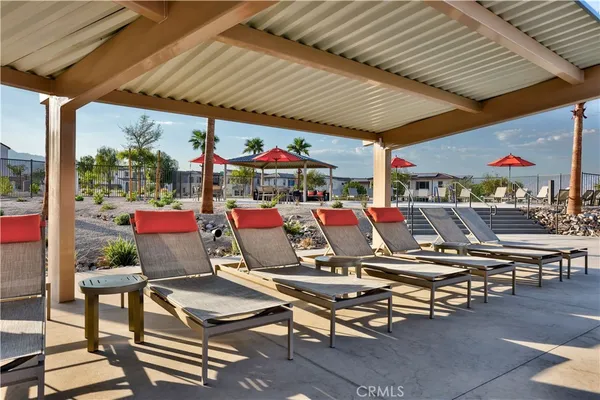 a view of a swimming pool with outdoor seating