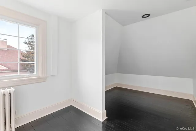 a view of small space with wooden floor and windows