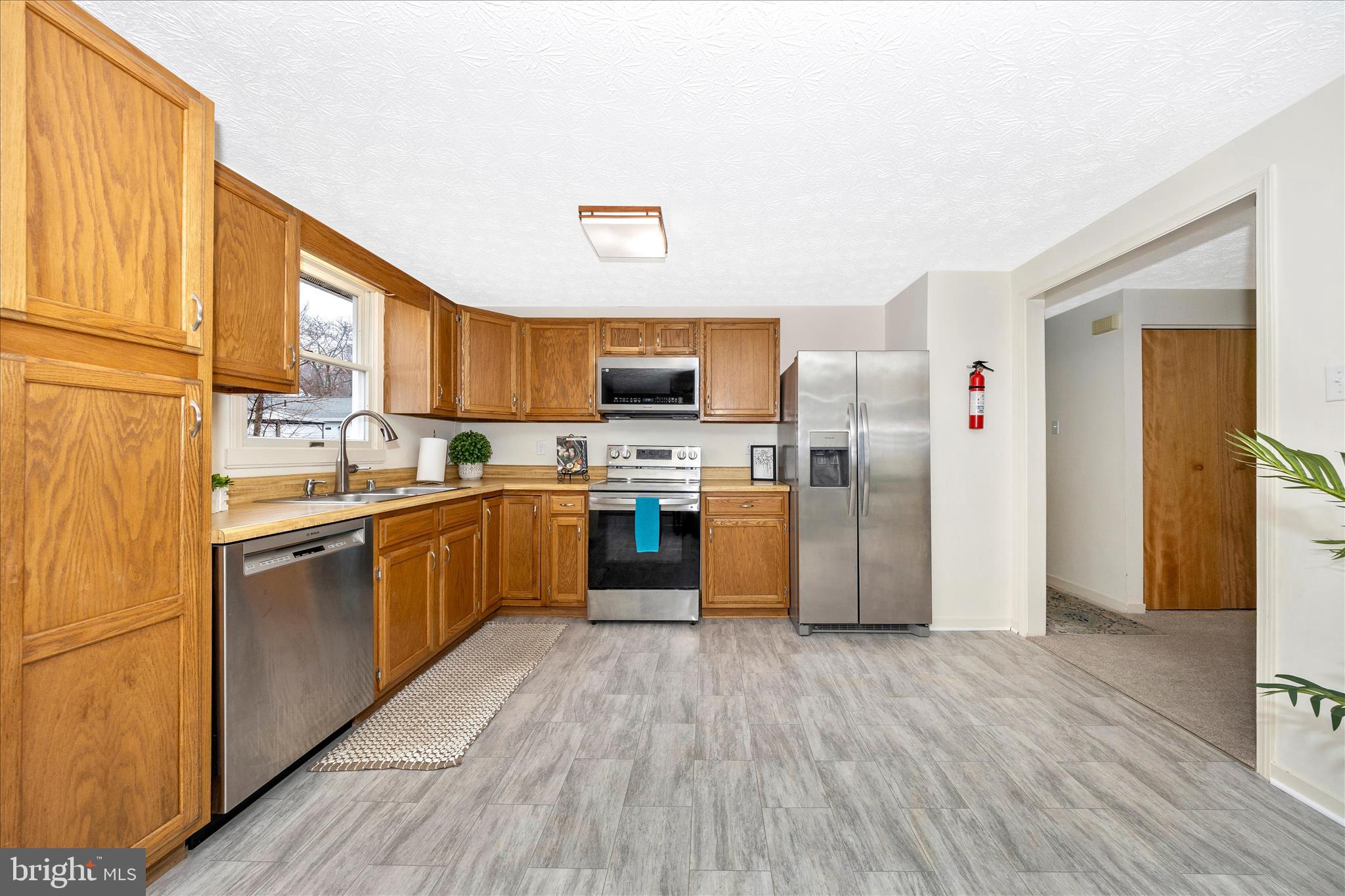 3 Contour Road Mount Airy, MD 21771 - Photo 9 of 54 a kitchen with stainless steel appliances a refrigerator and a stove top oven