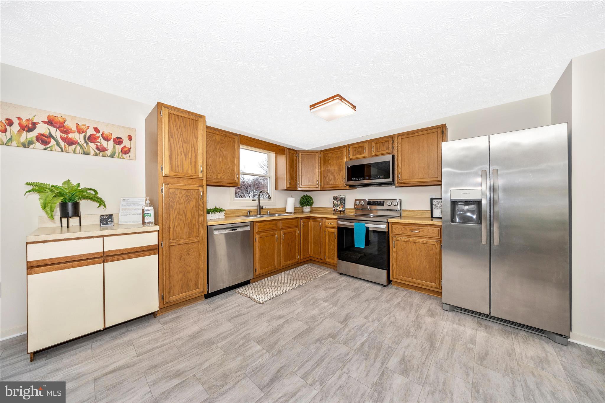 3 Contour Road Mount Airy, MD 21771 - Photo 10 of 54 a kitchen with stainless steel appliances granite countertop a refrigerator a sink dishwasher and a stove with wooden floor