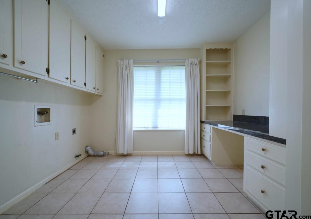 4505 Inverness Drive Tyler, TX 75703 - Photo 11 of 46 a kitchen with white cabinets and a window