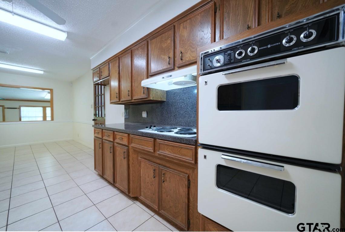 4505 Inverness Drive Tyler, TX 75703 - Photo 14 of 46 a kitchen with stainless steel appliances a stove a microwave and sink