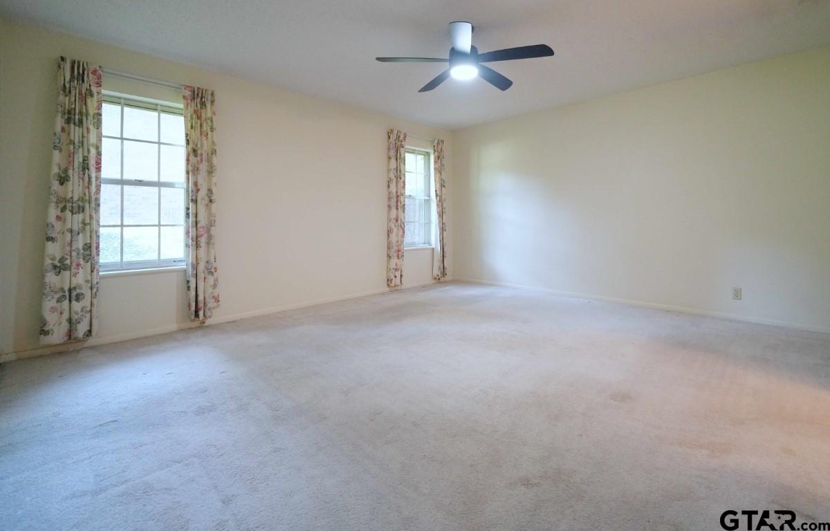 4505 Inverness Drive Tyler, TX 75703 - Photo 32 of 46 an empty room with windows and ceiling fan