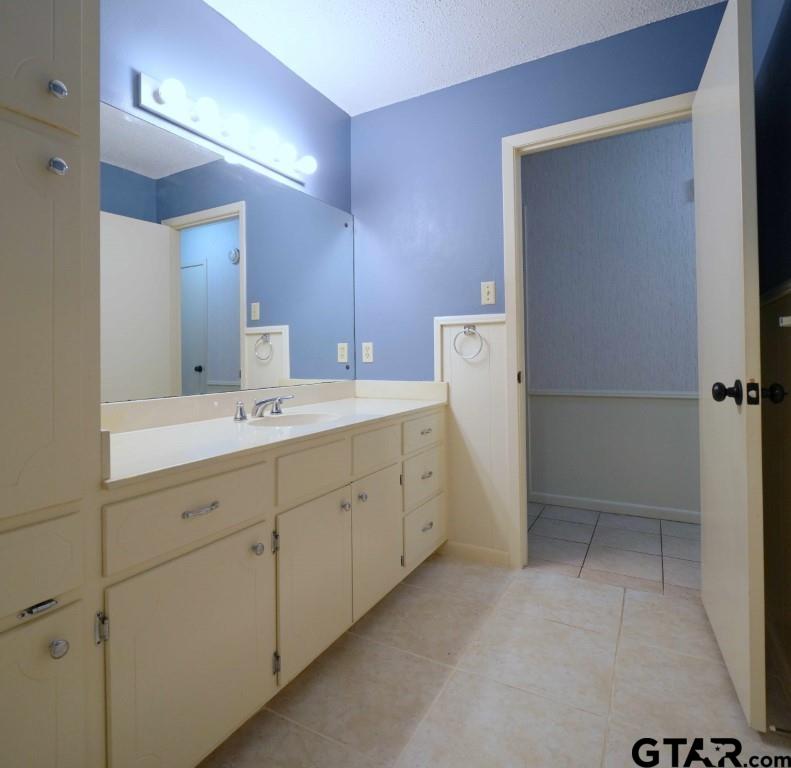 4505 Inverness Drive Tyler, TX 75703 - Photo 38 of 46 a spacious bathroom with a double vanity sink a toilet and a mirror