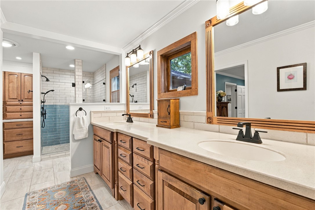604 Ridgecrest Drive Clemson, SC 29631 - Photo 36 of 50 Exquisite wood cabinetry and stone counters highlight this updated bathroom with a walk-in shower.