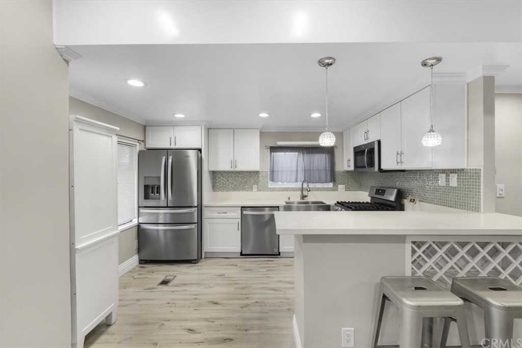 437 West Carson Street, Unit 32A Carson, CA 90745 - Photo 1 of 1 a kitchen with stainless steel appliances granite countertop a refrigerator sink and stove