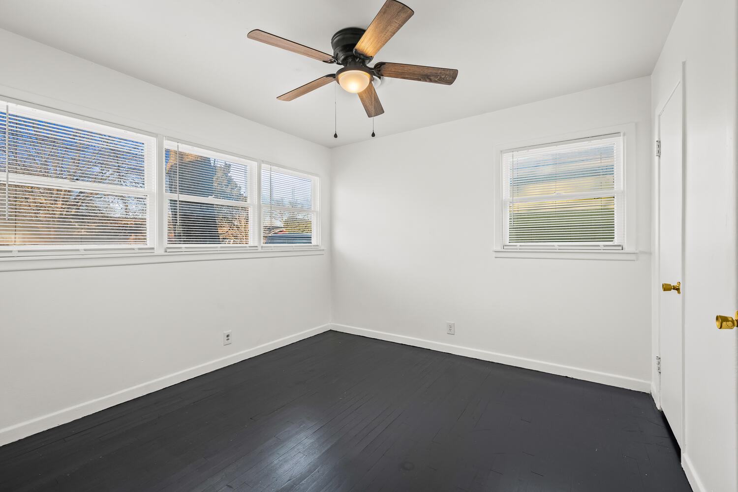 1609 39th Street Lubbock, TX 79412 - Photo 11 of 23 an empty room with wooden floor and windows