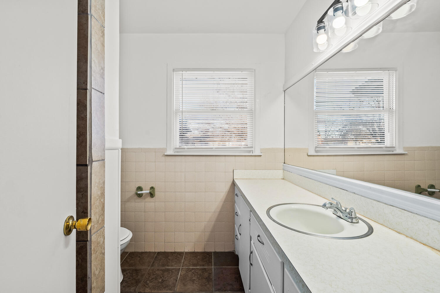 1609 39th Street Lubbock, TX 79412 - Photo 14 of 23 a bathroom with a granite countertop sink a window and a shower