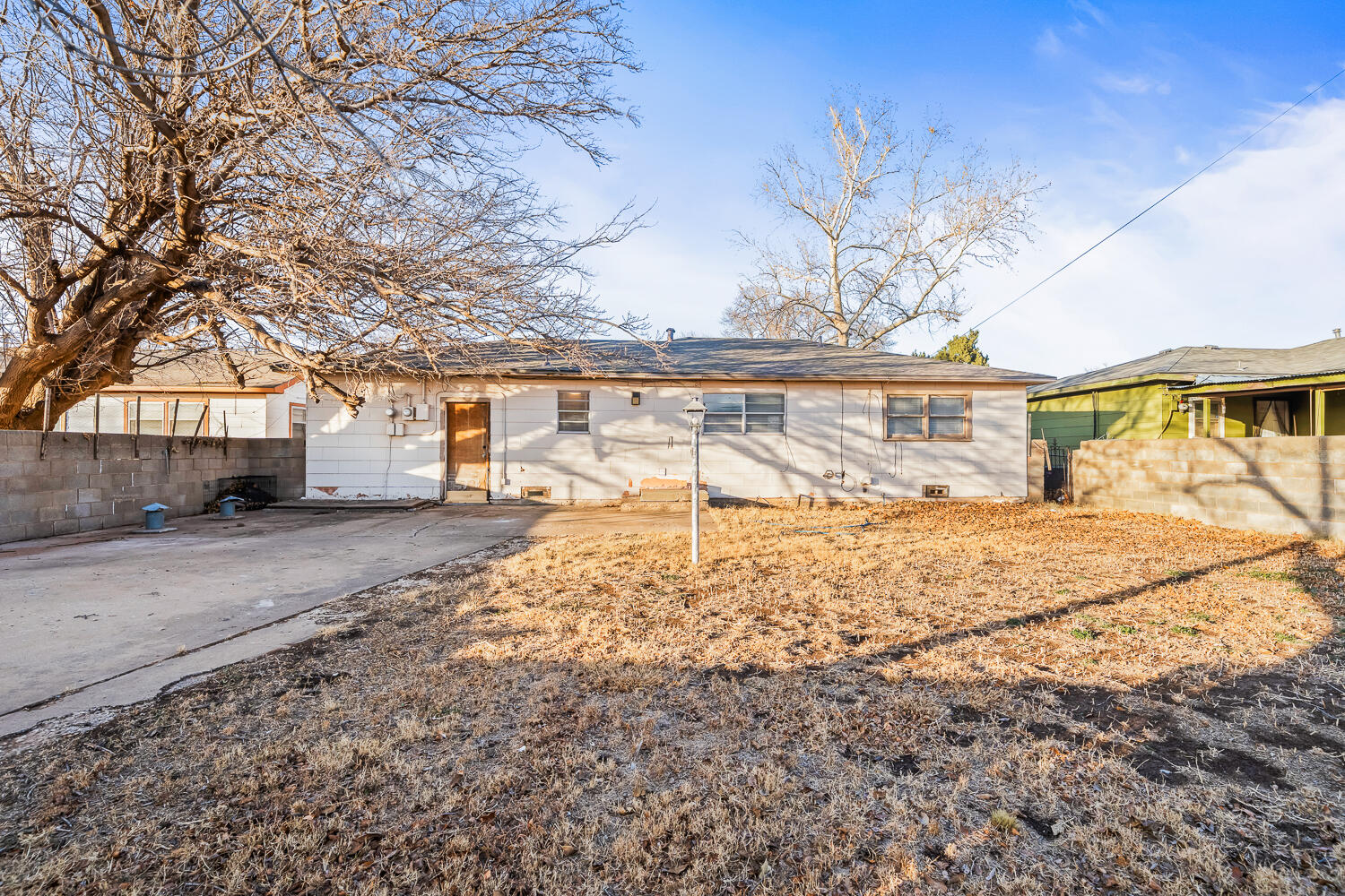 1609 39th Street Lubbock, TX 79412 - Photo 22 of 23 a view of a white house with a yard covered with snow
