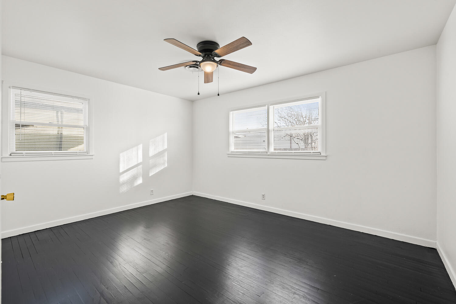 1609 39th Street Lubbock, TX 79412 - Photo 4 of 23 a view of an empty room with wooden floor and a window