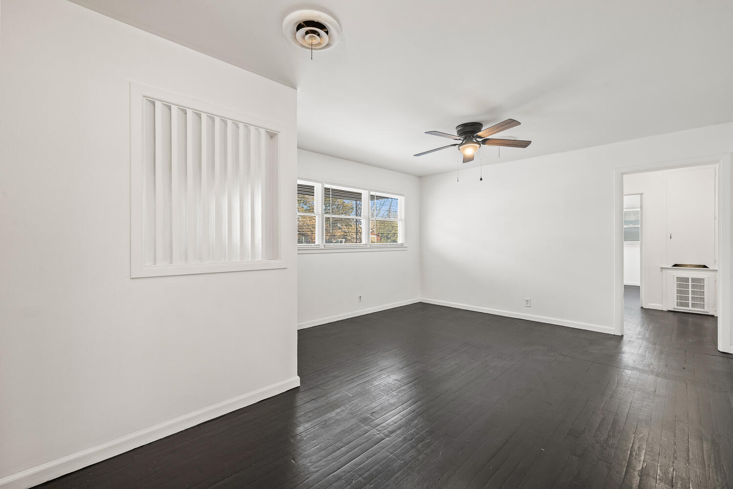 1609 39th Street Lubbock, TX 79412 - Photo 5 of 23 wooden floor in an empty room with a window