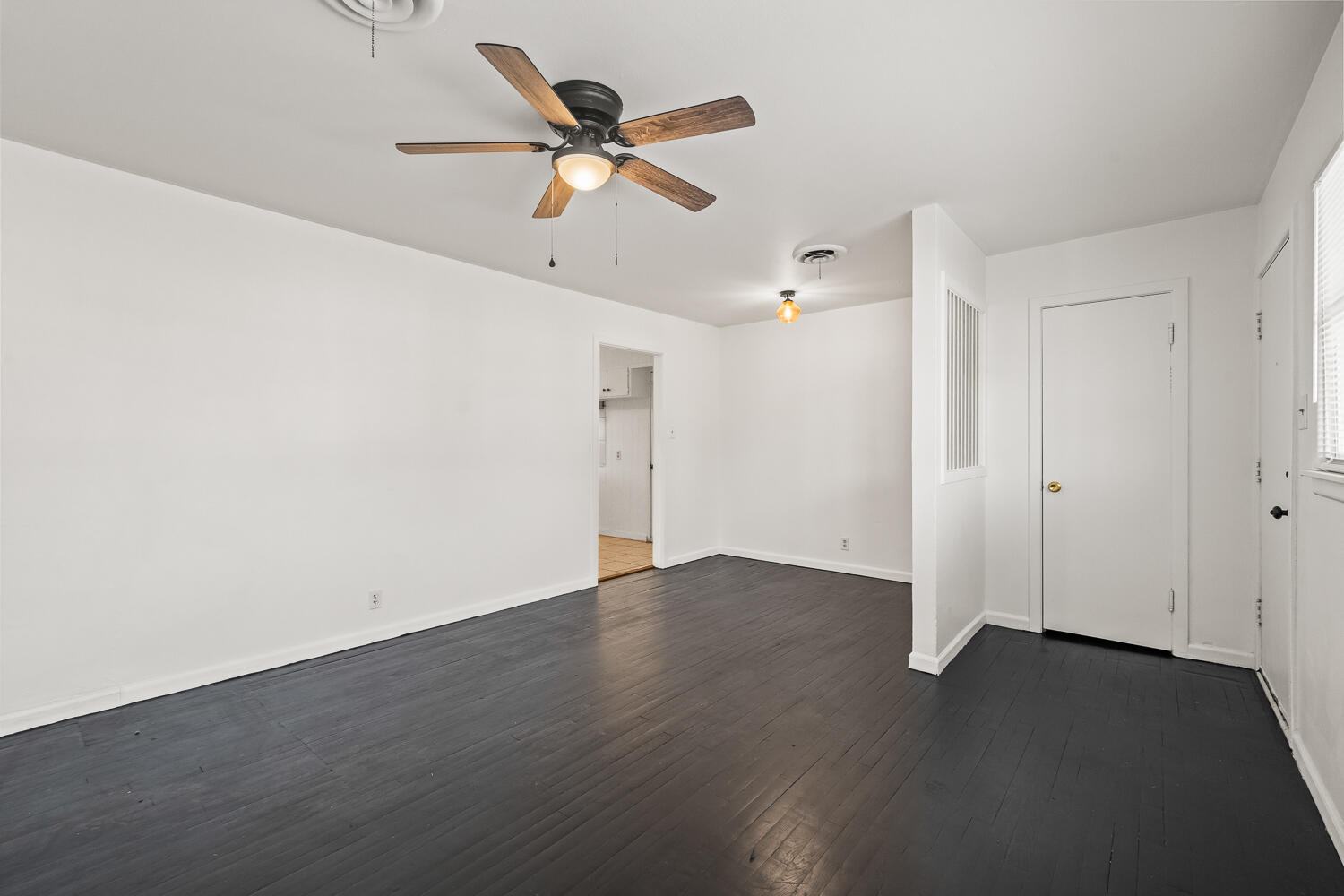 1609 39th Street Lubbock, TX 79412 - Photo 6 of 23 an empty room with wooden floor fan and windows