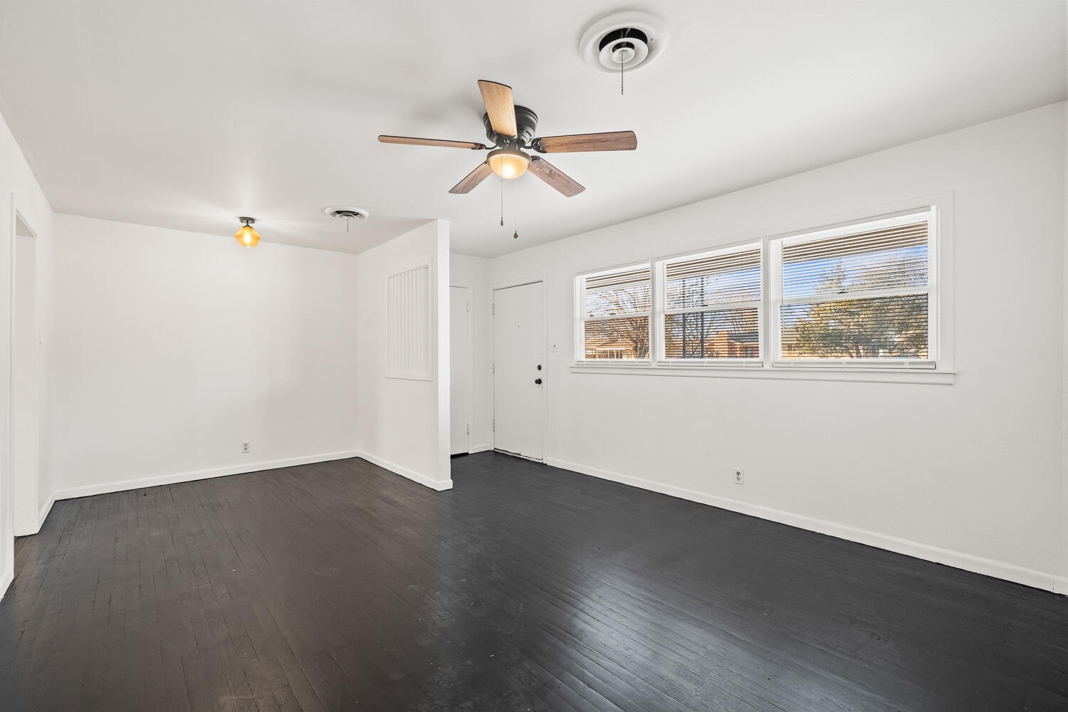 1609 39th Street Lubbock, TX 79412 - Photo 7 of 23 a view of empty room with wooden floor and fan