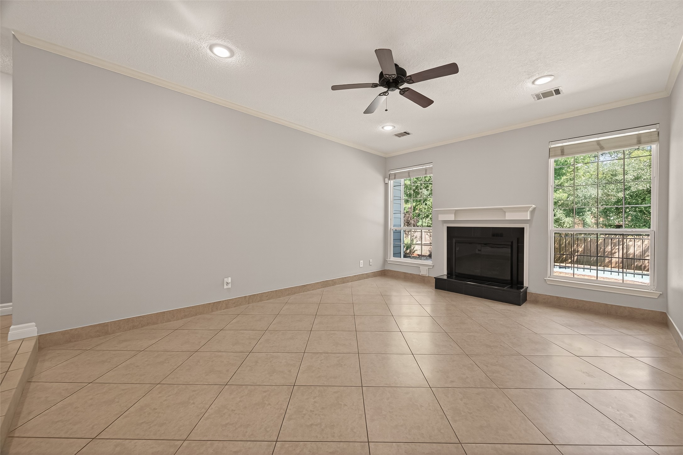 6131 Hampton Way Court Spring, TX 77389 - Photo 10 of 50 a view of an empty room with a fireplace and a window
