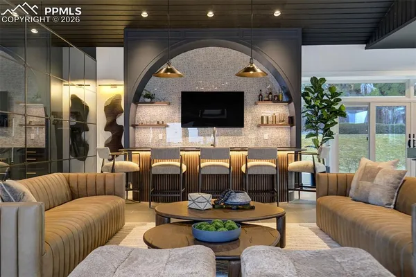 a living room with furniture a flat screen tv and a fireplace