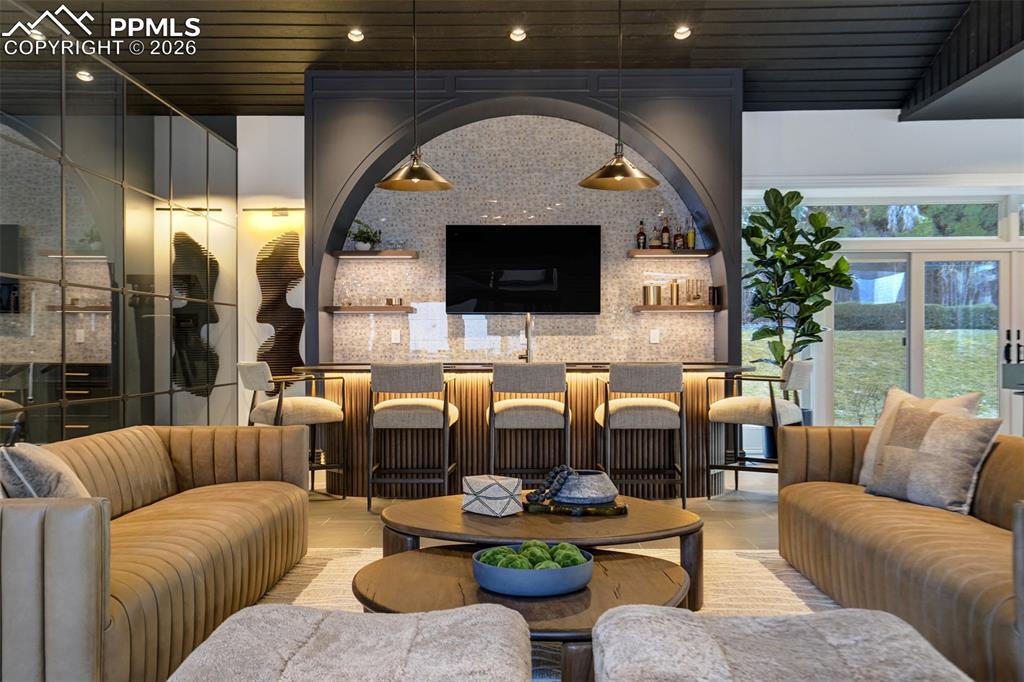 17 Pourtales Road Colorado Springs, CO 80906 - Photo 15 of 50 a living room with furniture a flat screen tv and a fireplace