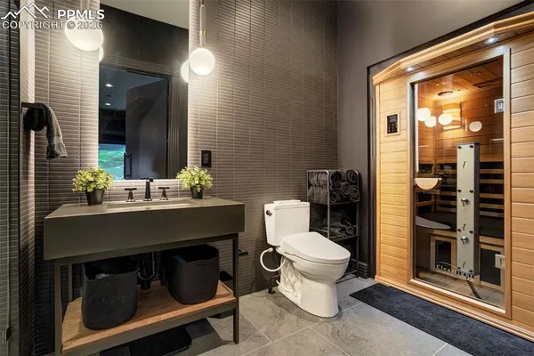 a bathroom with a sink toilet and shower