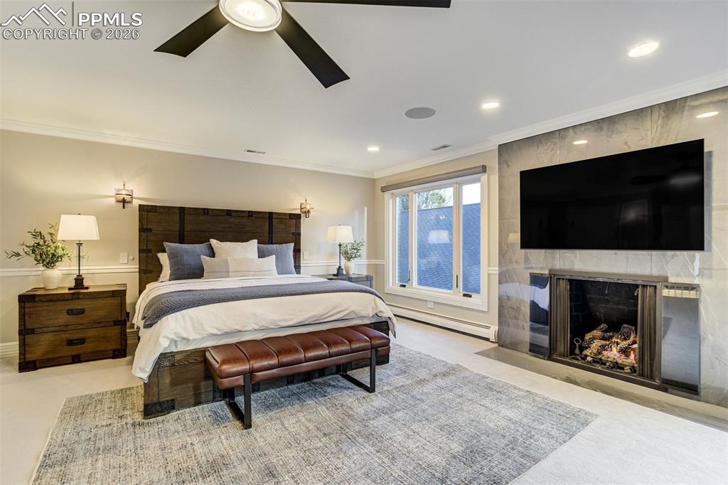17 Pourtales Road Colorado Springs, CO 80906 - Photo 29 of 50 a spacious bedroom with a bed and a flat screen tv