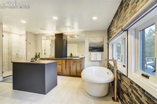 a bathroom with a tub sink toilet and mirror