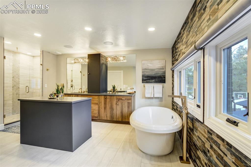 17 Pourtales Road Colorado Springs, CO 80906 - Photo 30 of 50 a bathroom with a tub sink toilet and mirror