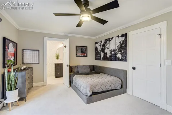 a bedroom with a large bed and a chandelier