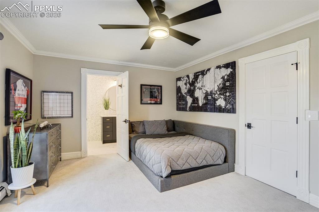 17 Pourtales Road Colorado Springs, CO 80906 - Photo 32 of 50 a bedroom with a large bed and a chandelier