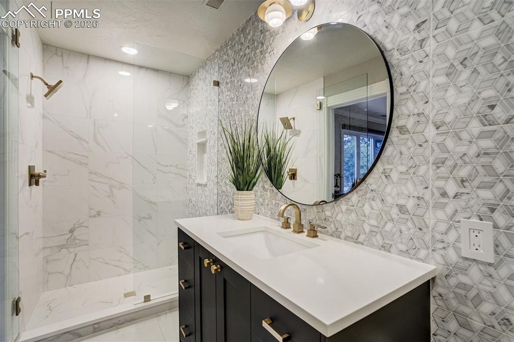 17 Pourtales Road Colorado Springs, CO 80906 - Photo 33 of 50 a bathroom with a sink and a mirror