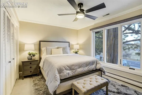 a bedroom with a bed and a large window