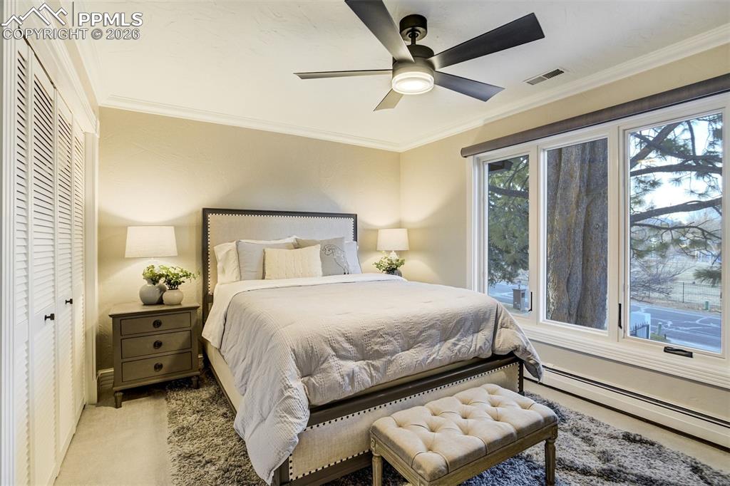 17 Pourtales Road Colorado Springs, CO 80906 - Photo 36 of 50 a bedroom with a bed and a large window