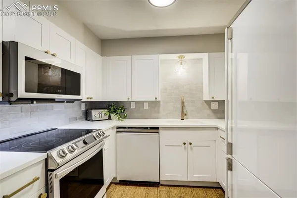 a kitchen with a sink stove and microwave