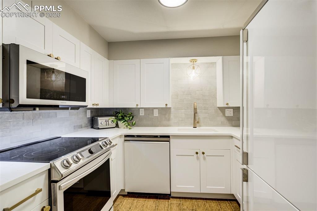 17 Pourtales Road Colorado Springs, CO 80906 - Photo 39 of 50 a kitchen with a sink stove and microwave