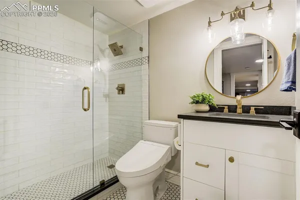 a bathroom with a toilet sink and shower