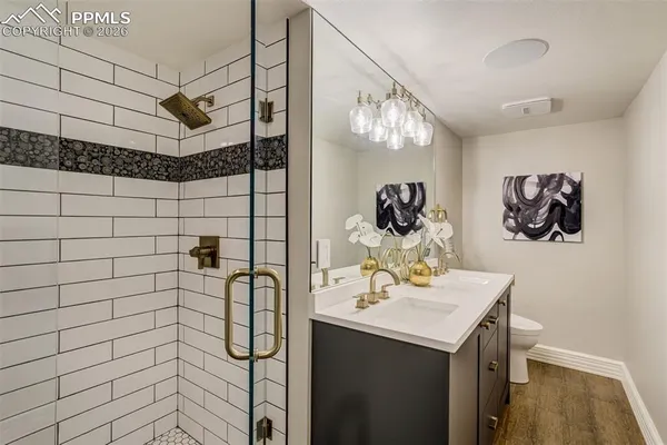 a bathroom with a sink mirror and vanity