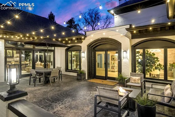 a living room with furniture and floor to ceiling windows