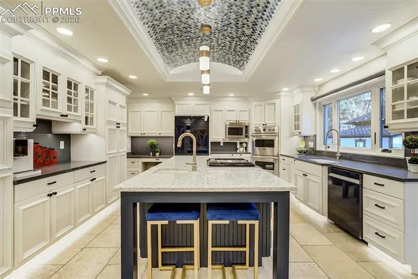 a kitchen with stainless steel appliances granite countertop a sink and cabinets