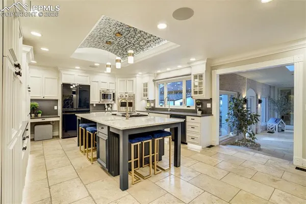 a kitchen with kitchen island a sink stove and refrigerator