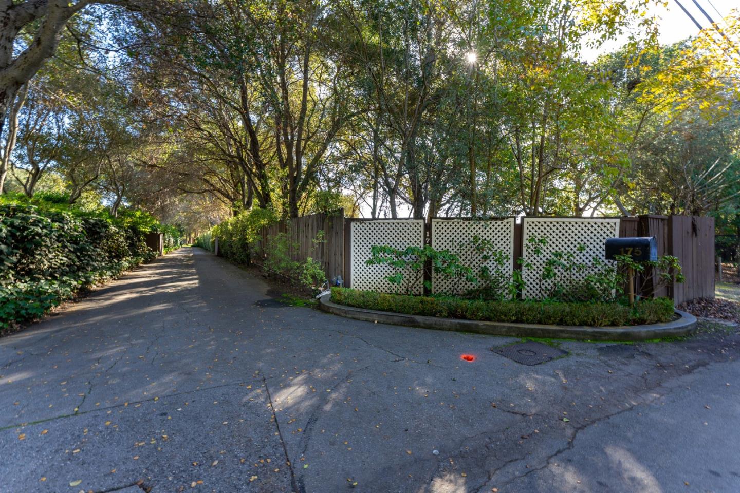 175 Isabella Avenue Atherton, CA 94027 - Photo 1 of 38 a view of a street with a bench and trees