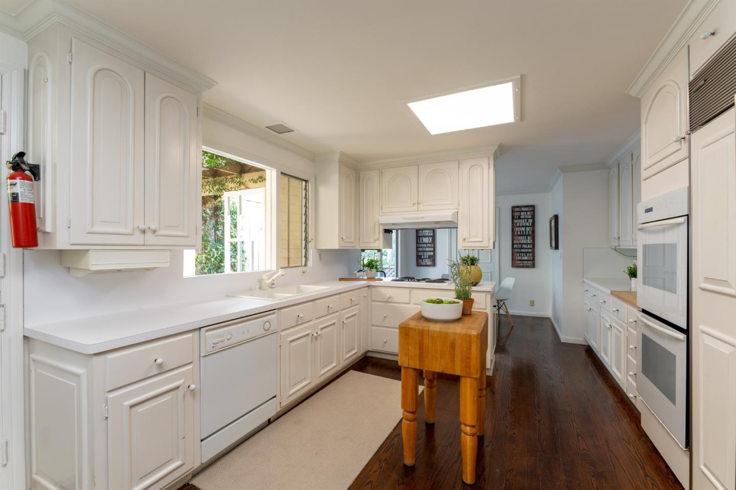 175 Isabella Avenue Atherton, CA 94027 - Photo 13 of 38 a kitchen with stainless steel appliances granite countertop sink stove refrigerator and cabinets