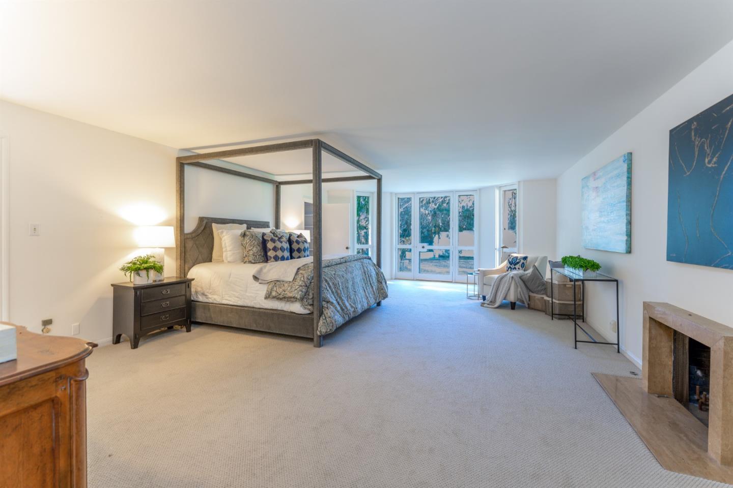 175 Isabella Avenue Atherton, CA 94027 - Photo 18 of 38 a bedroom with furniture and a fireplace