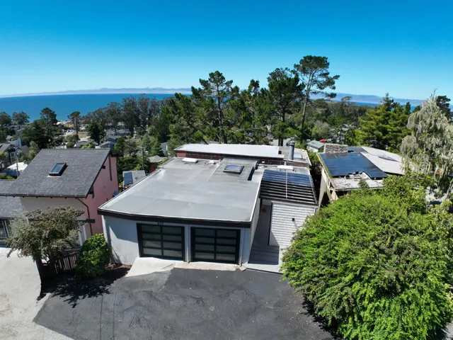 an aerial view of a house with yard