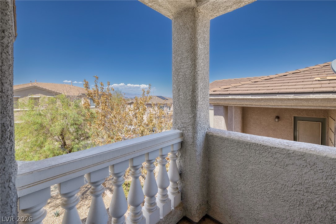 226 Priority Point Street Henderson, NV 89012 - Photo 23 of 32 A private covered balcony features classic balusters and stucco pillars overlooking neighborhood views.