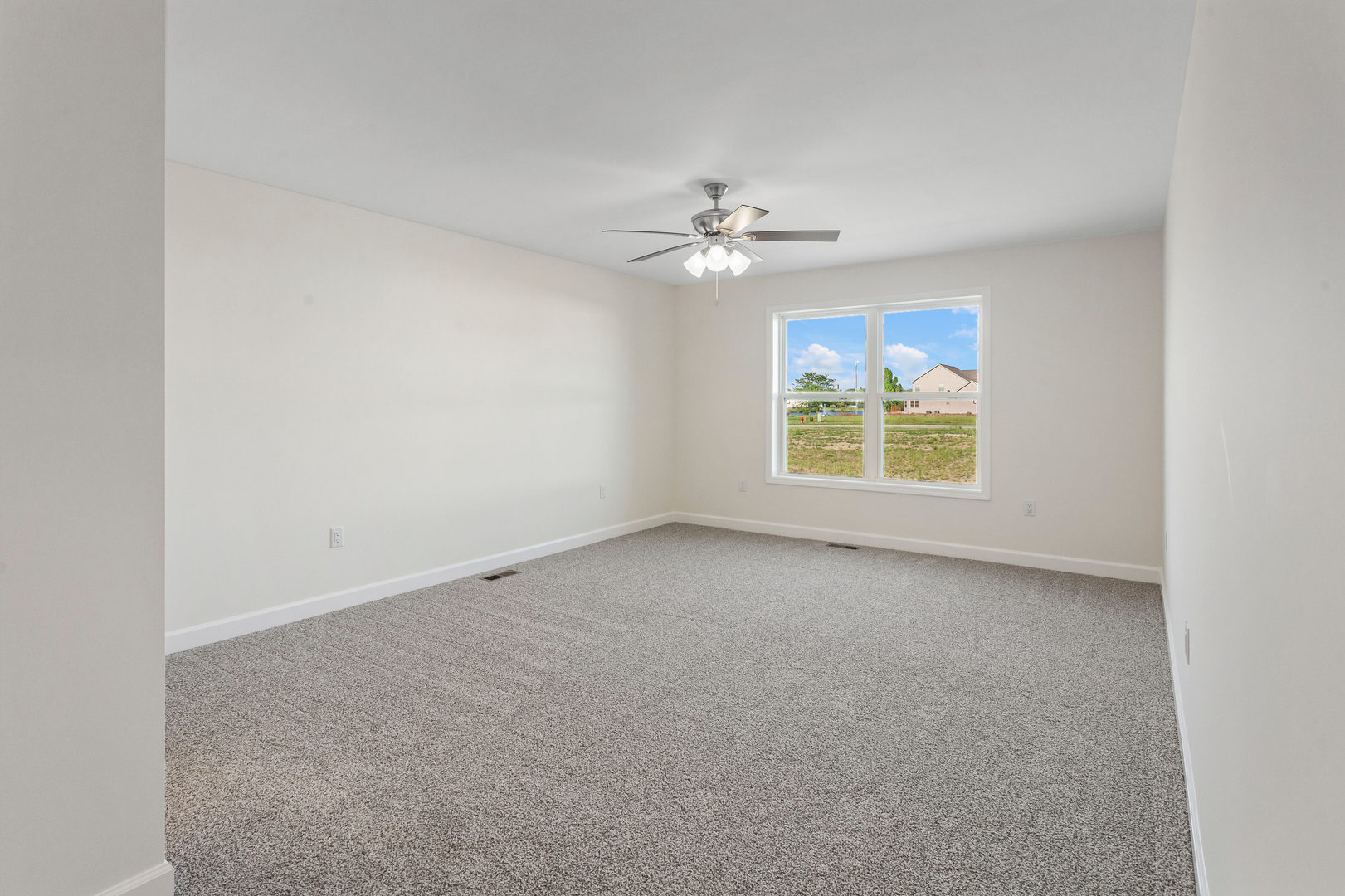 504 Patterson Drive Bloomington, IL 61701 - Photo 11 of 26 an empty room with windows and ceiling fan