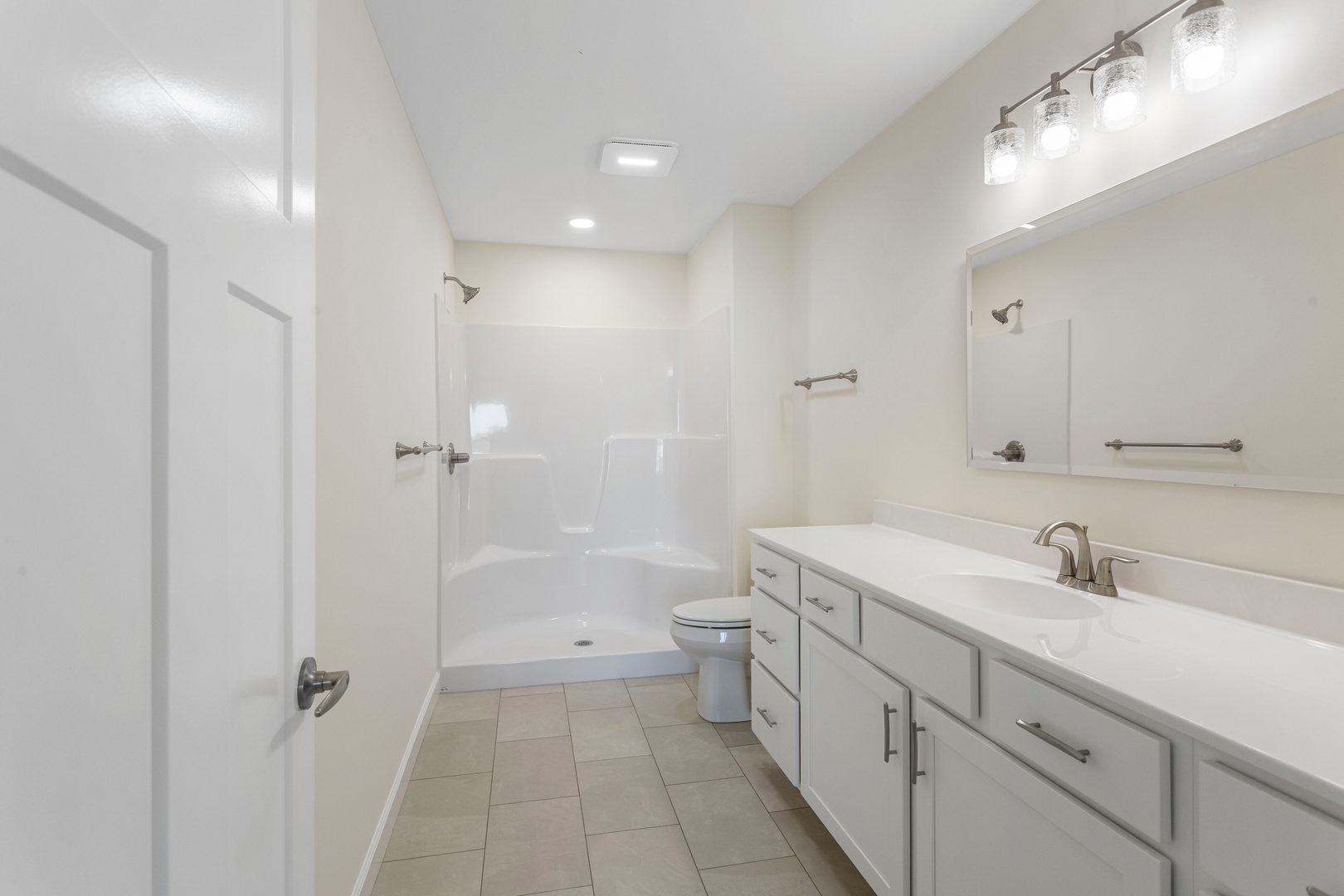 504 Patterson Drive Bloomington, IL 61701 - Photo 13 of 26 a bathroom with a sink a toilet and shower