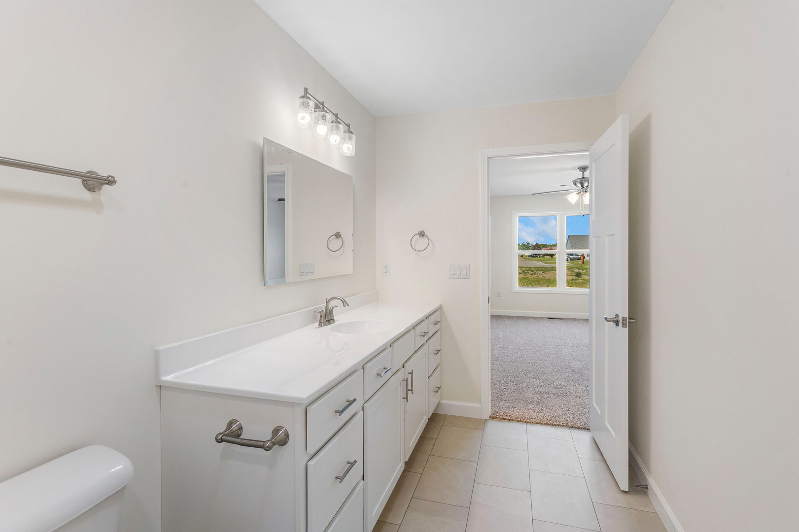 504 Patterson Drive Bloomington, IL 61701 - Photo 14 of 26 a bathroom with a double vanity sink mirror and bathtub