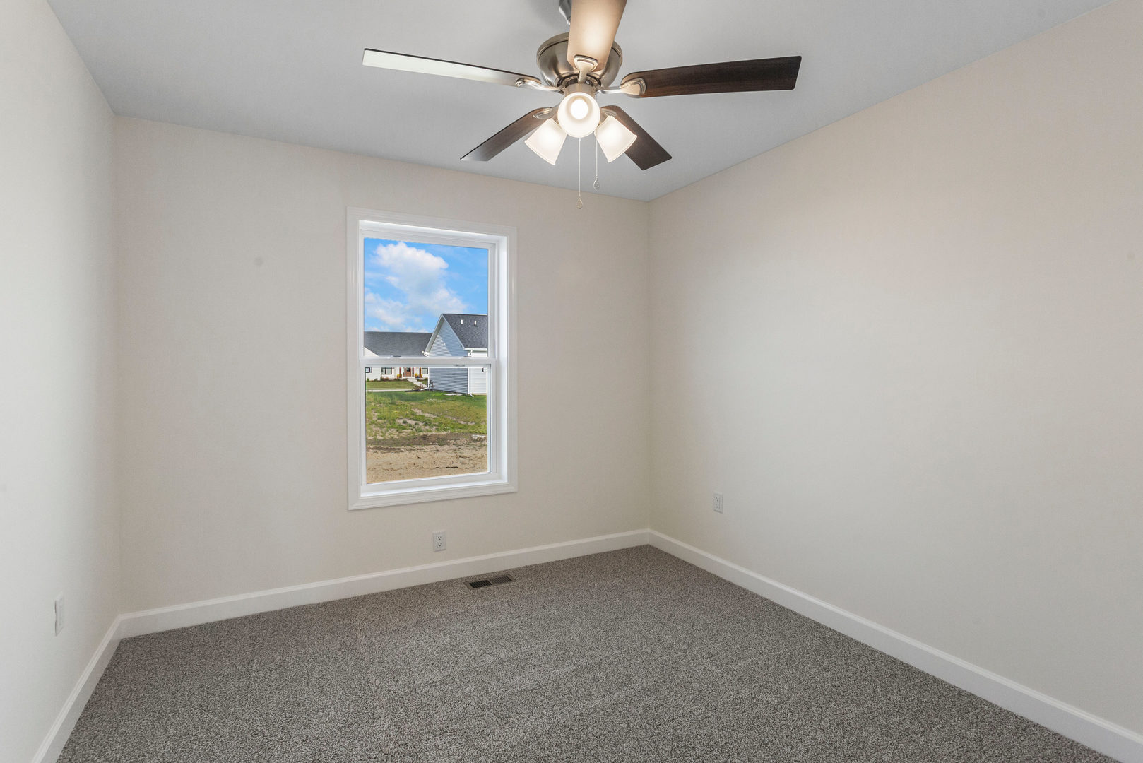 504 Patterson Drive Bloomington, IL 61701 - Photo 18 of 26 an empty room with a window and a fan